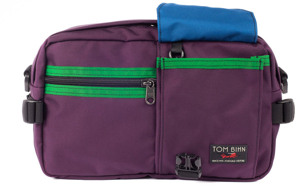 The LGD in Aubergine/Hunter/Island. Front view of the bag, buckle pocket lifted up showing the Island lining.